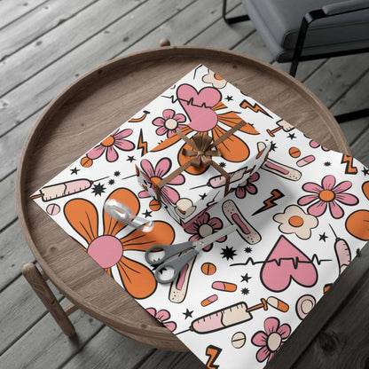 Nurse-themed gift wrapping with medical patterns and pink accents on a wooden table.