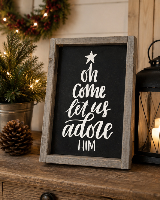 Decorative sign with Christmas text on a wooden surface with festive decorations.