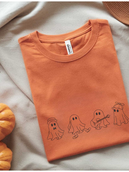 Orange folded t-shirt with embroidered playful ghost crew designs for Halloween and fall.