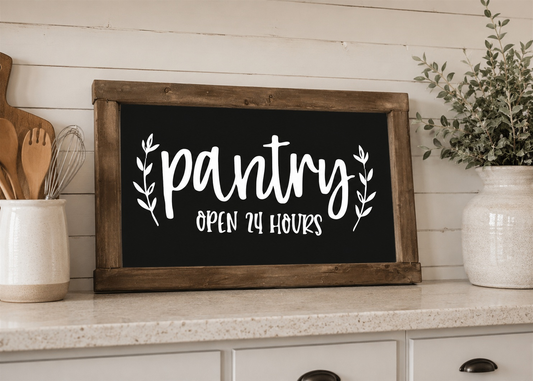 Wooden sign with 'pantry open 24 hours' text on a kitchen counter.