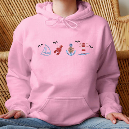 Pink coastal sweatshirt with ocean life embroidery and vintage boat design.