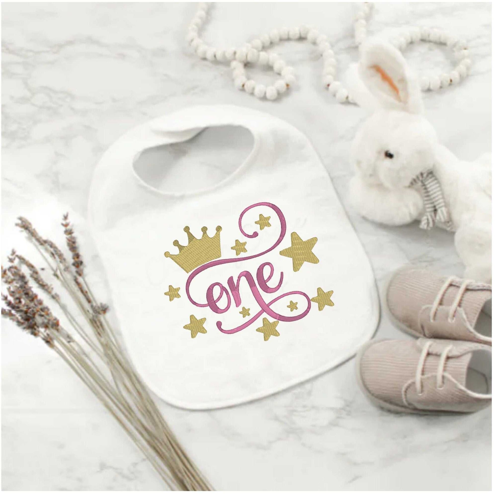 Custom embroidered first birthday bib with crown and stars design, perfect for baby shower gift.