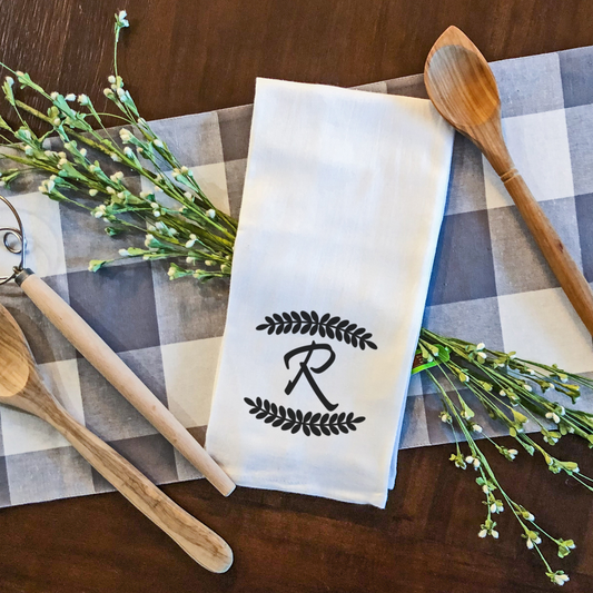Personalized initial tea towel with leaf border design