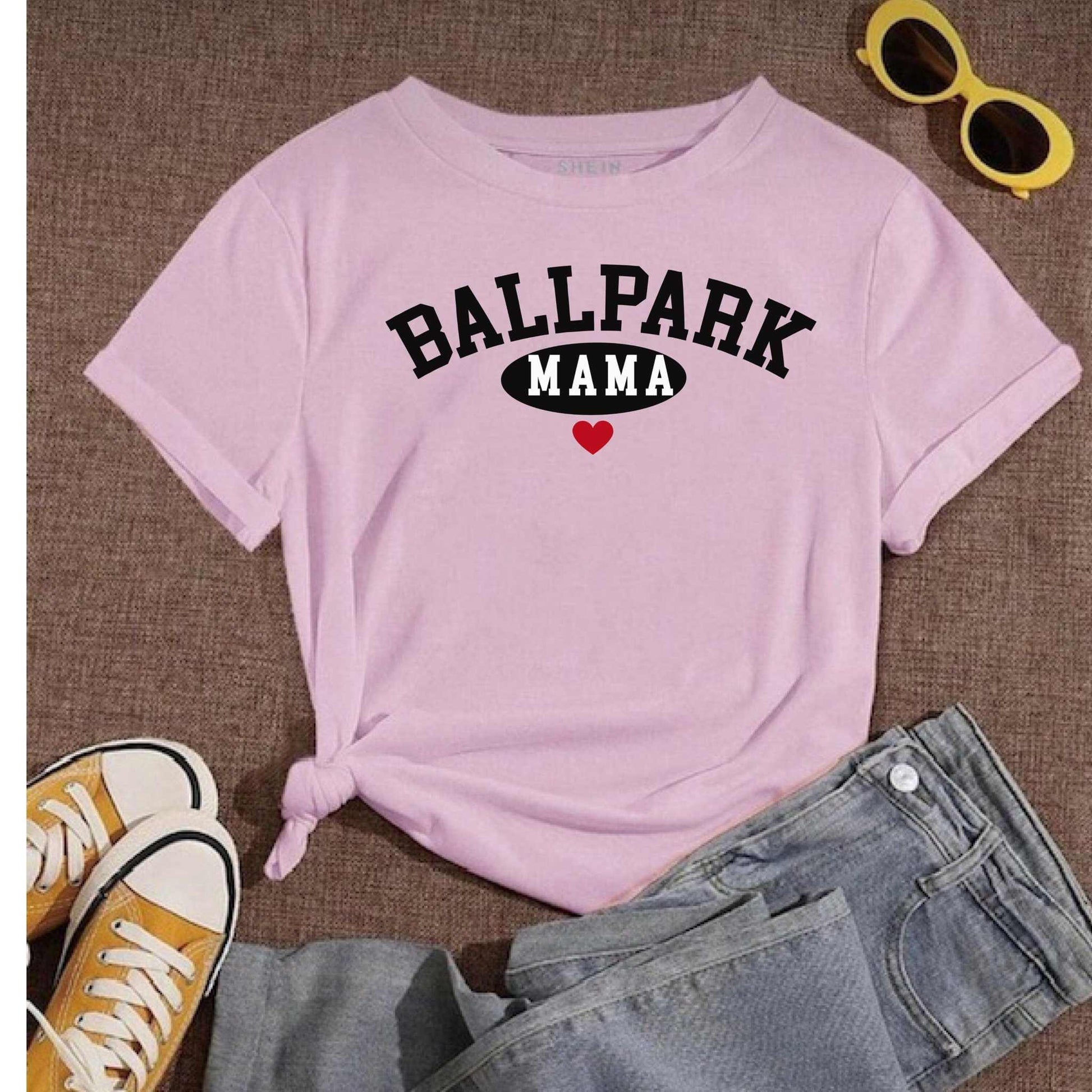 Ballpark Mama Baseball T-Shirt laid out with jeans and sneakers; yellow sunglasses nearby.