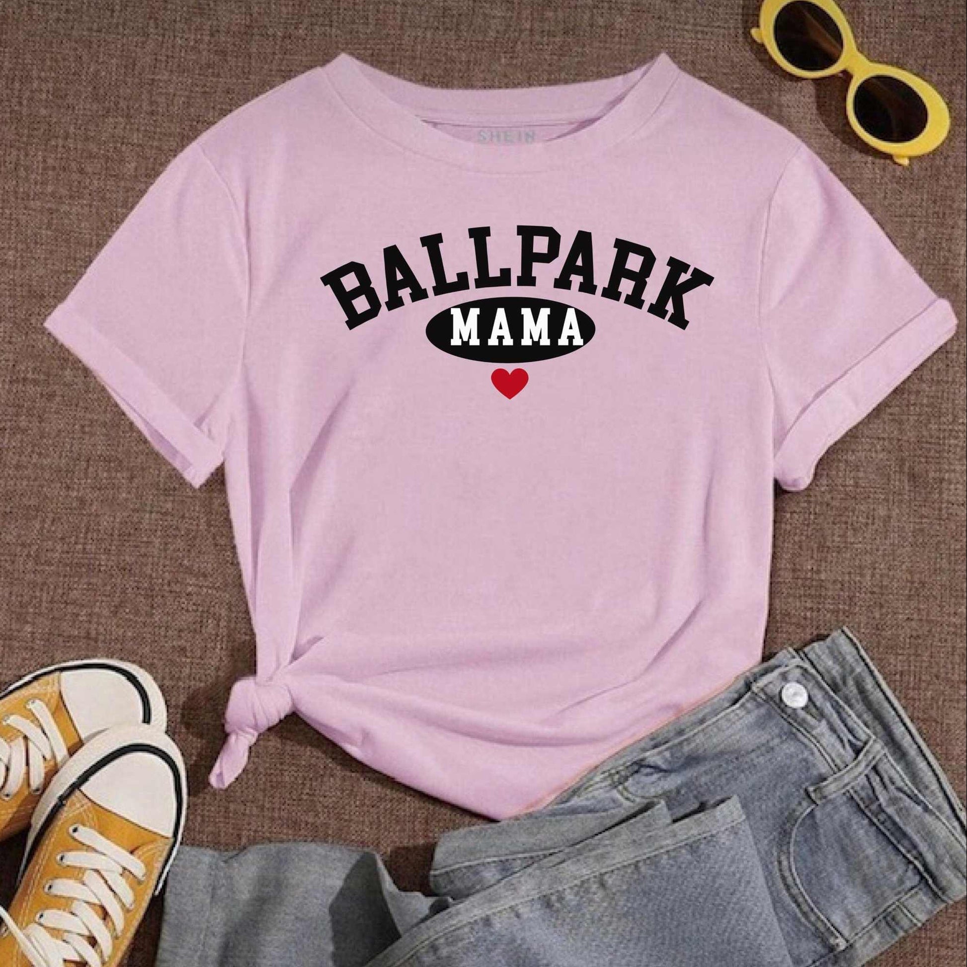 Ballpark Mama Baseball T-Shirt laid out with jeans and sneakers; yellow sunglasses nearby.