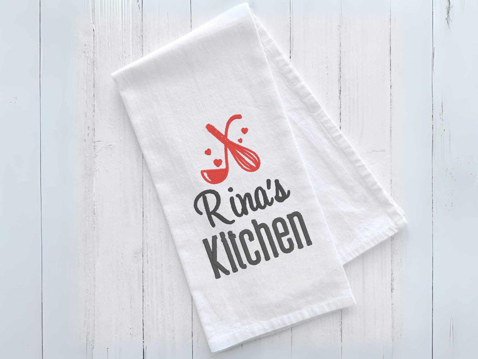 Personalized kitchen towel with custom name, embroidered whisk and spoon design, and heart accents