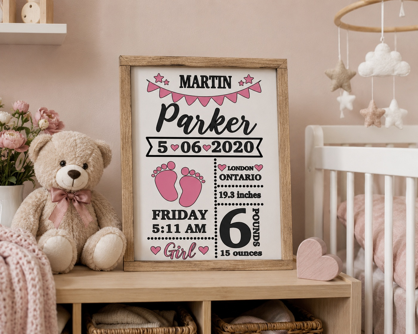 Framed birth announcement sign for Martin Parker in a baby's room with a teddy bear and crib.