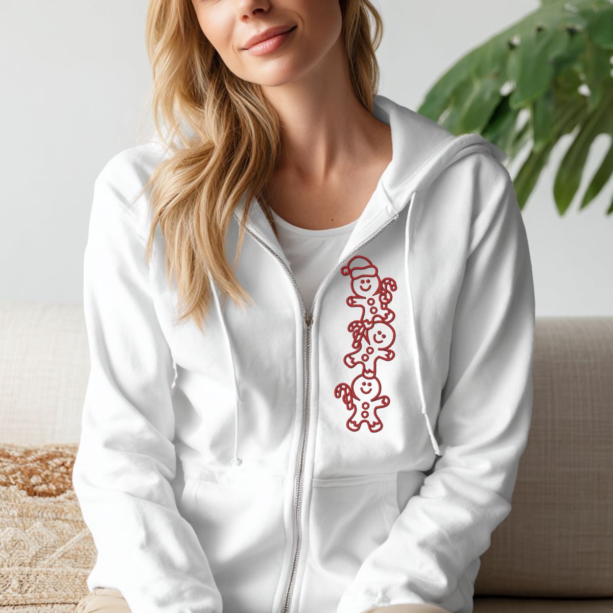 Full Zip Embroidered Sweatshirt in white, featuring a full zip, hood, and vertical red gingerbread character embroidery.