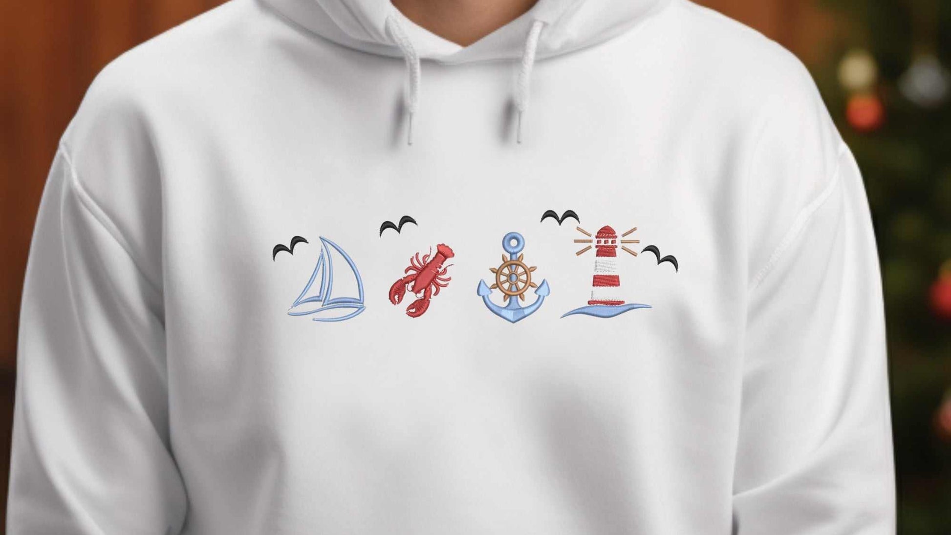 Embroidered coastal sweatshirt with ocean life and vintage boat design.