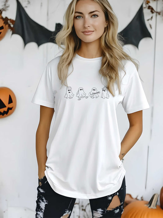 woman wearing white embroidered ghost crew Halloween t-shirt with black distressed pants in fall decor setting