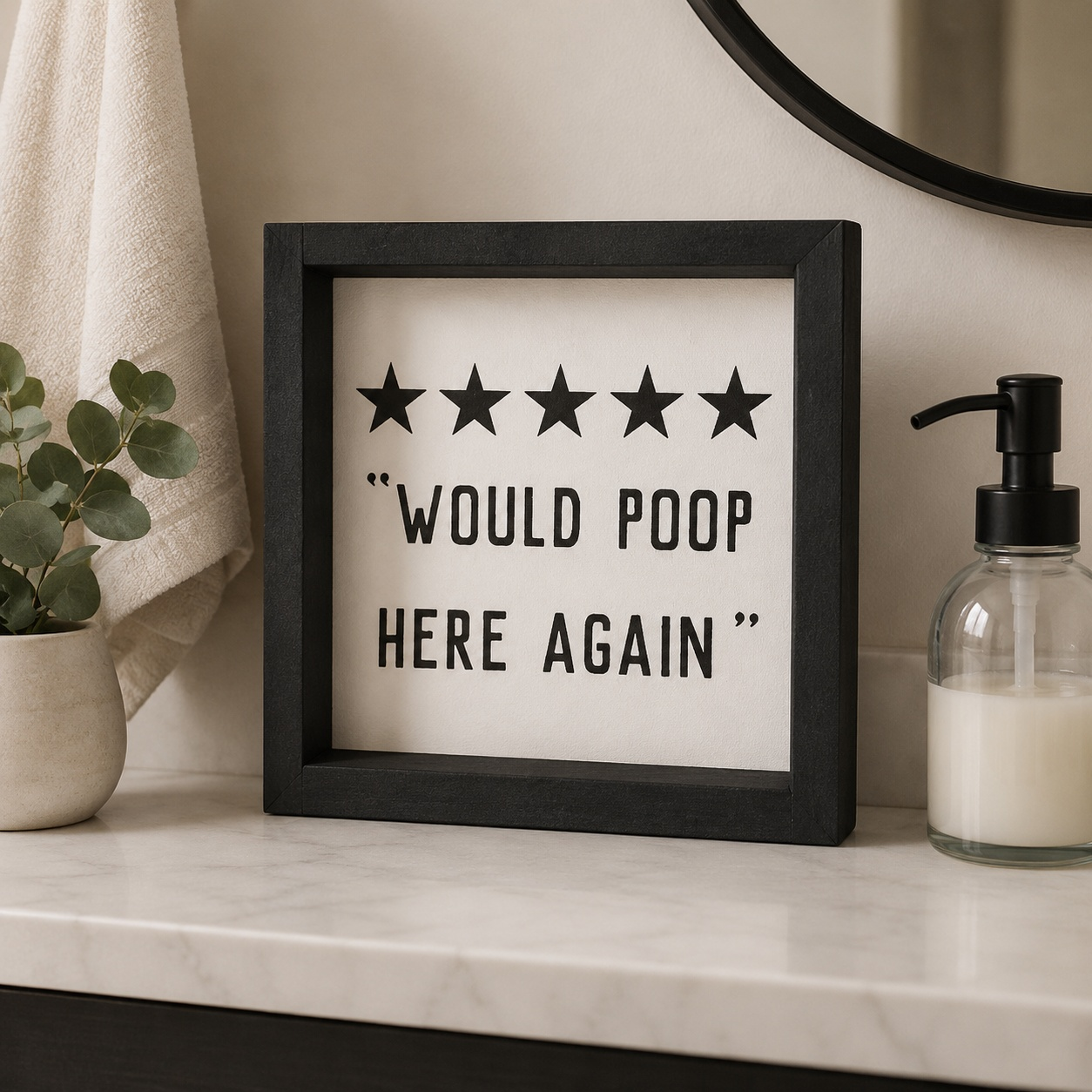 Decorative sign with five stars and text on a bathroom shelf.