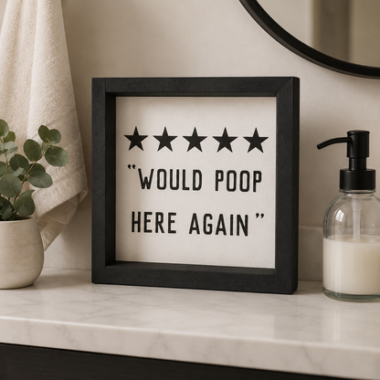 Decorative sign with five stars and text on a bathroom shelf.
