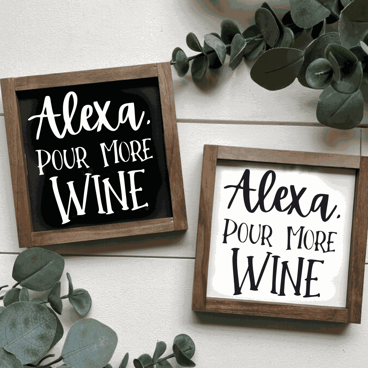Handcrafted "Alexa Pour More Wine" wood signs with black or white backgrounds and contrasting lettering, framed in stained wood.