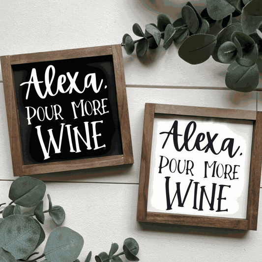 Handcrafted "Alexa Pour More Wine" wood signs with black or white backgrounds and contrasting lettering, framed in stained wood.