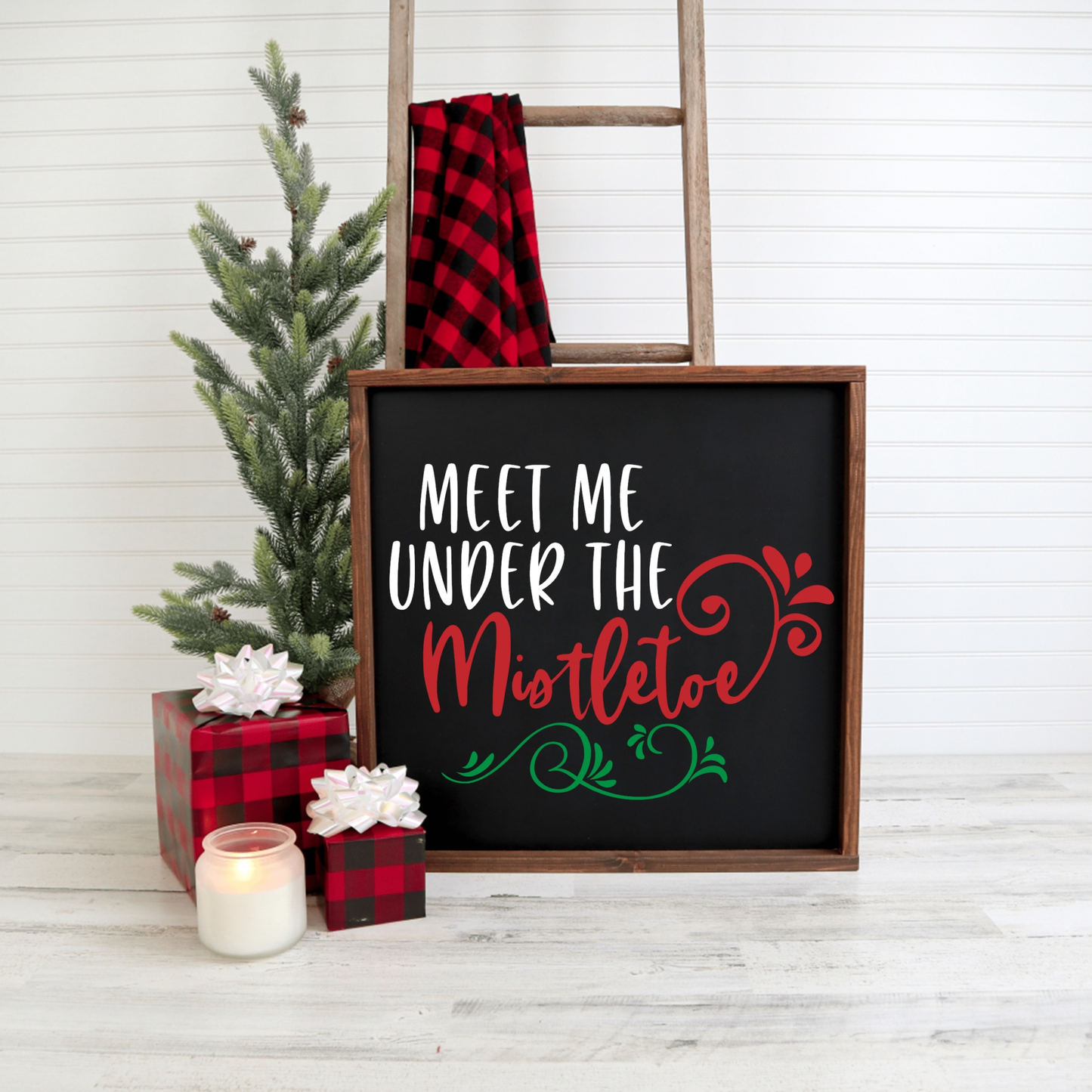 Meet Me Under the Mistletoe wood framed sign with festive holiday decor.