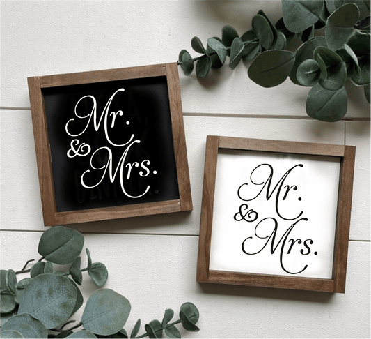 Handcrafted "Mr and Mrs" framed wood signs in black and white backgrounds with leafy decor.