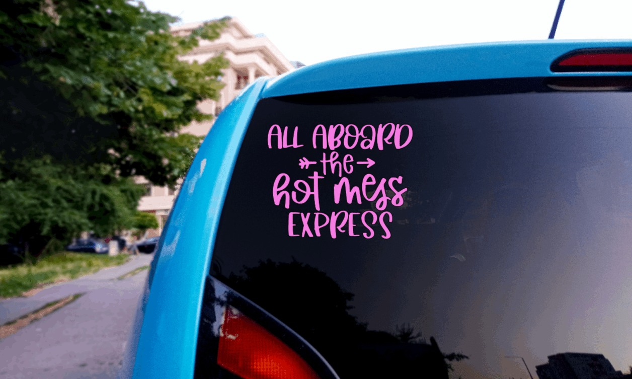 Pink "All Aboard the Hot Mess Express" vinyl decal on car window.