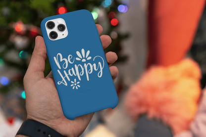 Be Happy Vinyl Sticker Decal on blue phone case near Christmas lights.