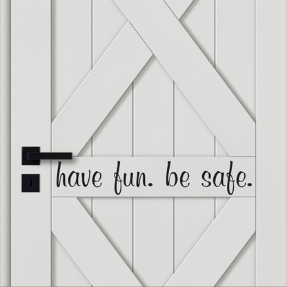 Vinyl door decal with "have fun. be safe." message in black font on a white door.