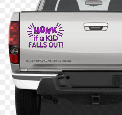 Funny car decal on truck tailgate reading "Honk if a Kid Falls Out" in purple letters.