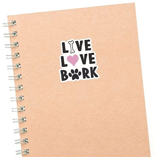 Live Love Bark dog sticker on spiral notebook, vinyl decal, suitable for various surfaces.