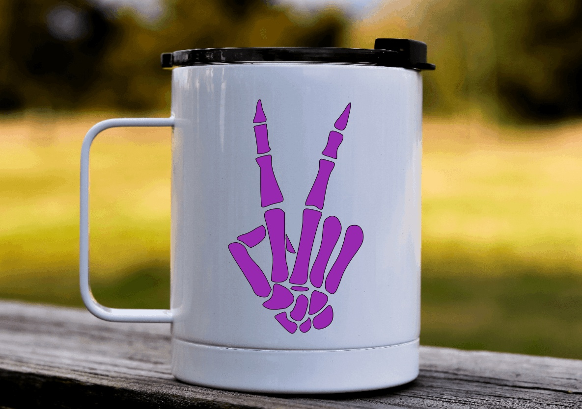 Skeleton hand peace sign decal sticker on white mug.