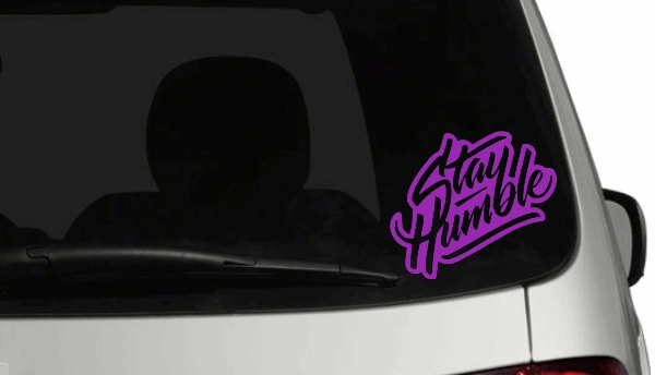 Stay Humble personalized car decal with colored background on a vehicle's rear window.