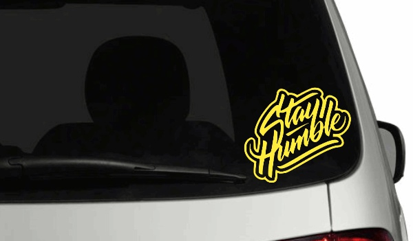 Stay Humble yellow personalized car decal on rear window.