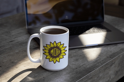 Personalized sunflower vinyl monogram decal on a white mug near a laptop.