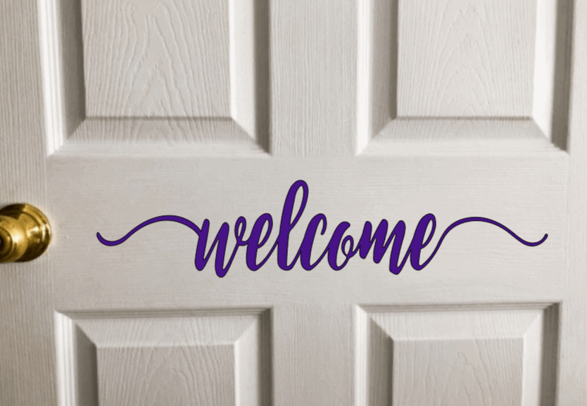 Vinyl "Welcome" door decal on white door.