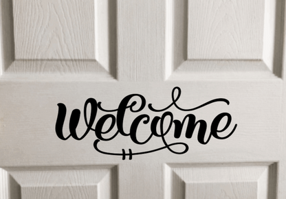 Welcome vinyl door decal on white wood panel door.