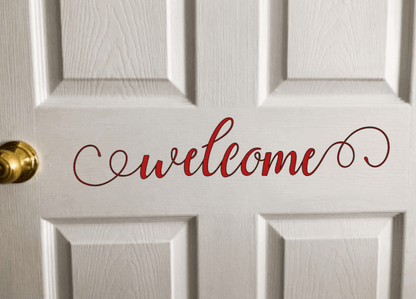 Welcome vinyl door decal in elegant script on white door.