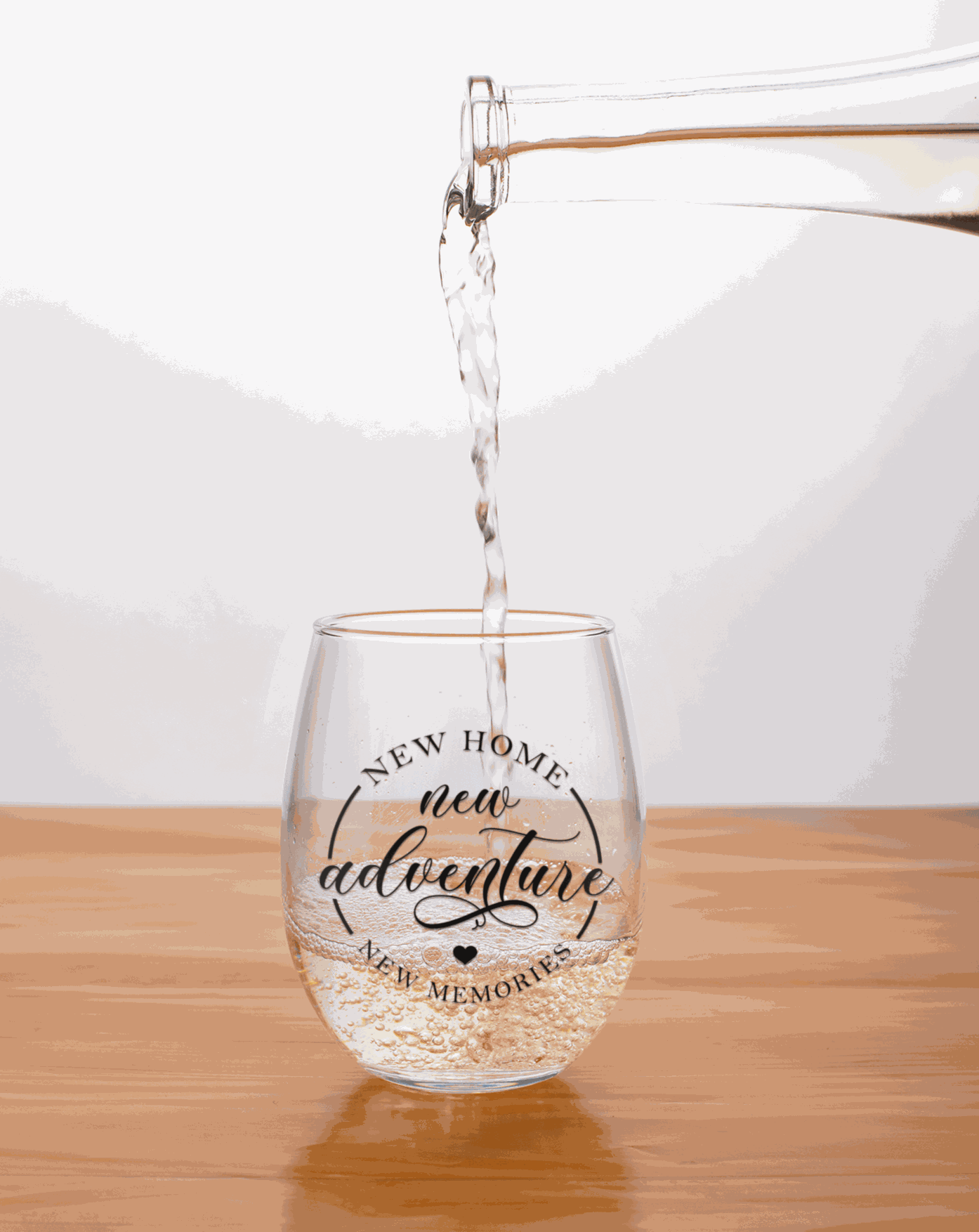 Set of two 20 oz stemless wine glasses with "New Home New Adventures" design. Perfect gift for new homeowners.