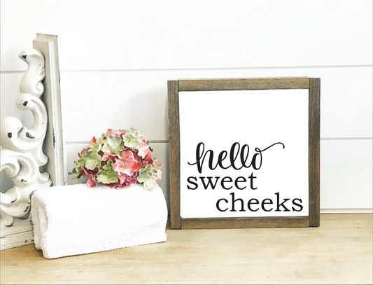 Handmade "Hello Sweet Cheeks" bathroom sign with wooden frame, farmhouse decor.