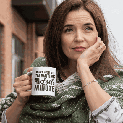 Ceramic coffee mug with "Don't Rush Me" design held by a woman.