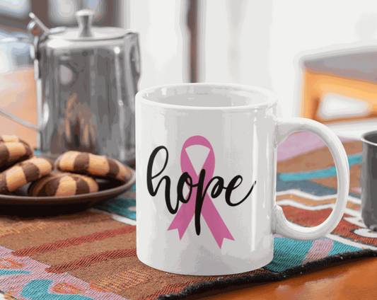 Hope and Pink Ribbon Cancer Awareness Mug on table with cookies and coffee pot.