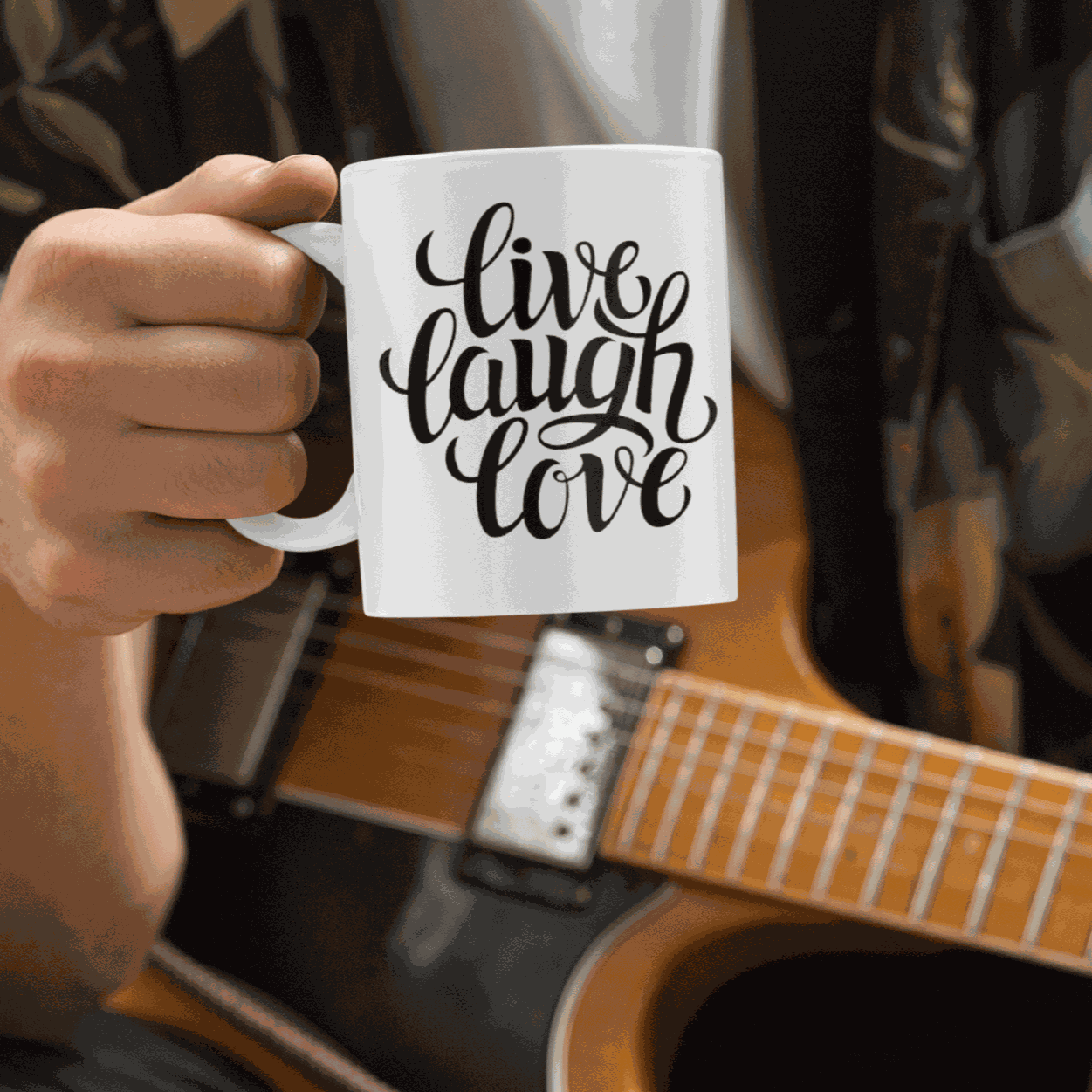 White ceramic coffee mug with "Live, Laugh, Love" design.
