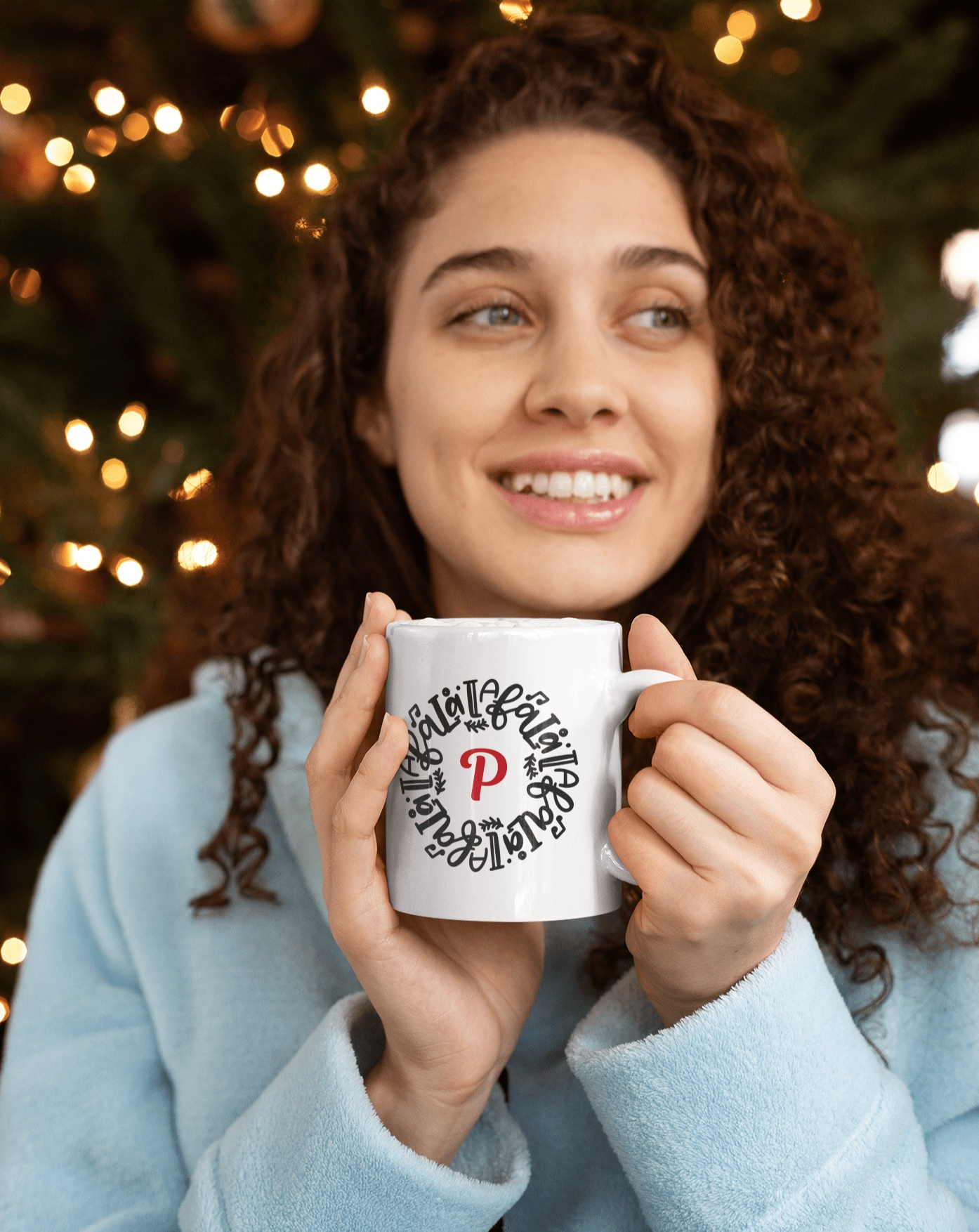 Personalized Christmas Mug with Initial "P" design held by woman in front of Christmas tree lights.