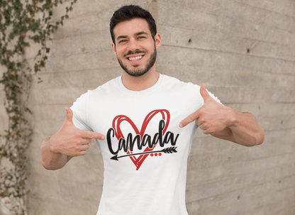 Man wearing a white Canadian T-shirt with a heart and arrow design, smiling outdoors.