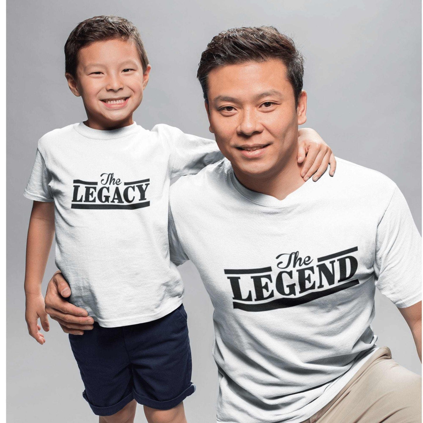 Father and son wearing matching "The Legend" and "The Legacy" shirts celebrating their bond