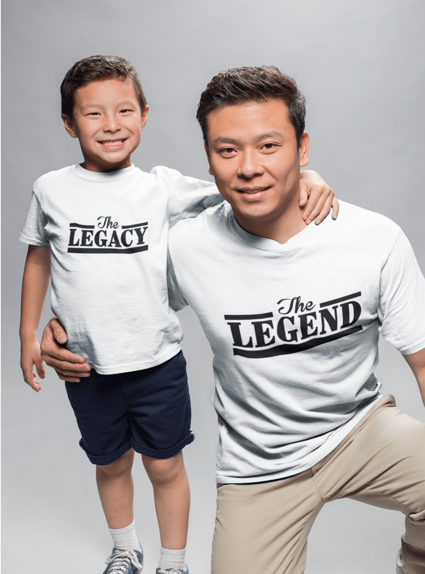 Father and son wearing matching white "The Legend" and "The Legacy" t-shirts celebrating their bond