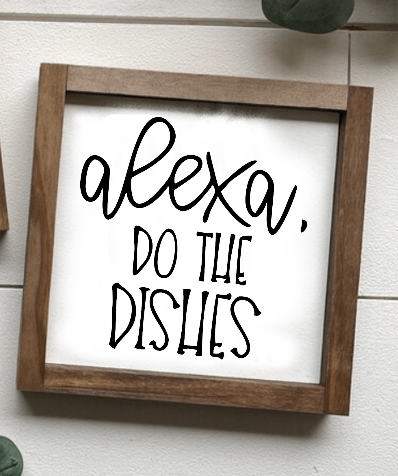 Handcrafted framed wood sign with "Alexa, Do The Dishes" text, featuring a stained frame and white background with black lettering.