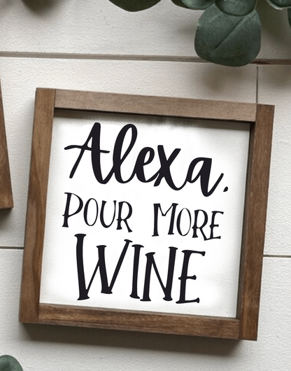 Handcrafted wood sign with "Alexa, Pour More Wine" text, framed in stained wood.