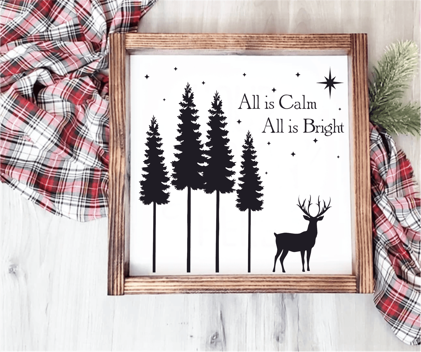 Christmas wood sign with "All is Calm, All is Bright" text, featuring pine trees and a reindeer silhouette.