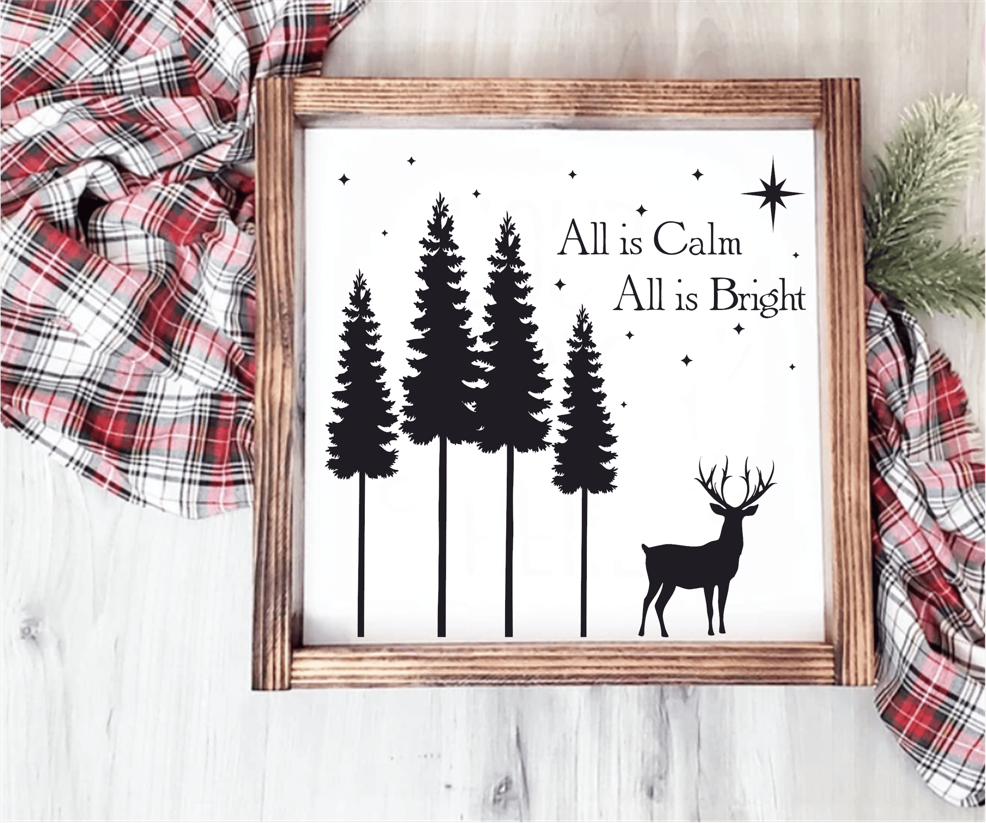 Christmas wood sign with "All is Calm, All is Bright" text, featuring pine trees and a reindeer silhouette.