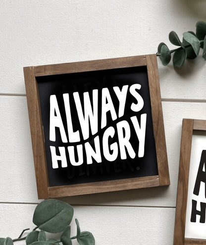 Handmade "Always Hungry" framed wood sign with black background and white lettering.
