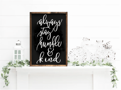 Always Stay Humble & Kind wood sign, handcrafted with black background and white lettering, displayed on a mantel with greenery.