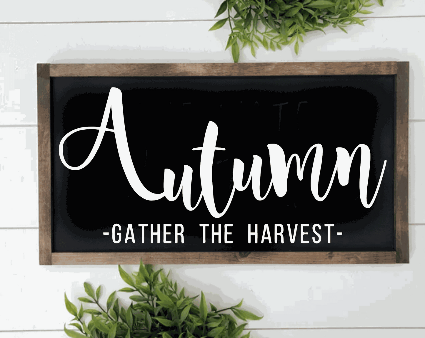 Handcrafted autumn wood sign with "Gather the Harvest" text in white on black background, framed in rustic pine wood.