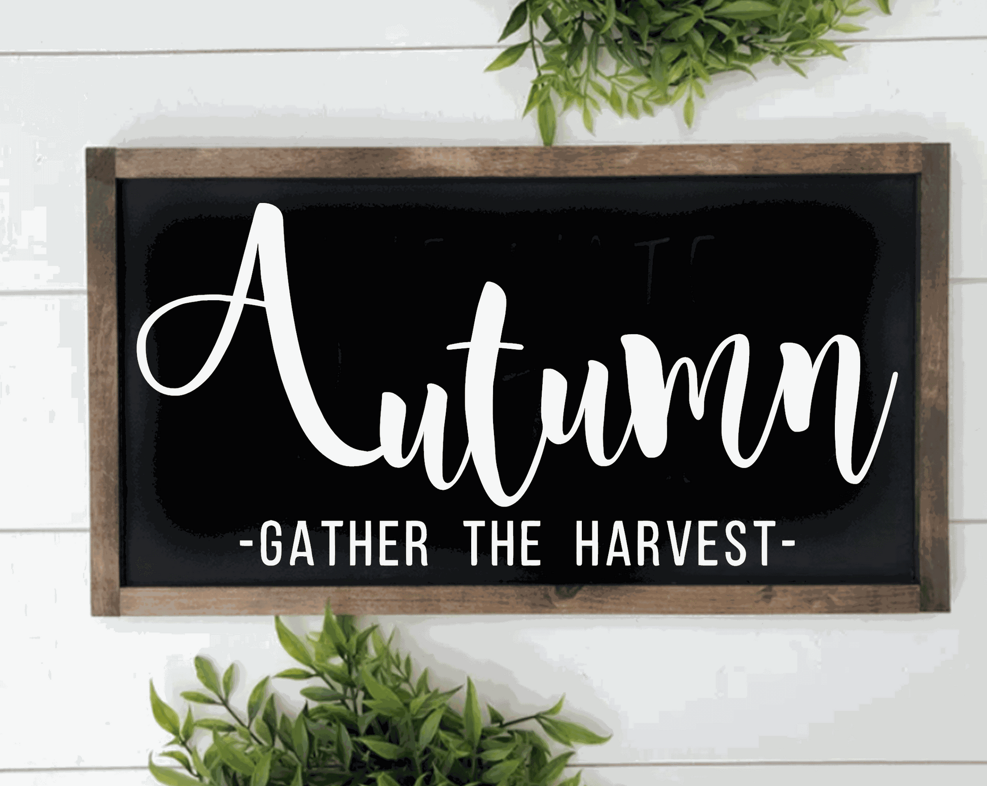 Handcrafted autumn wood sign with "Gather the Harvest" text in white on black background, framed in rustic pine wood.