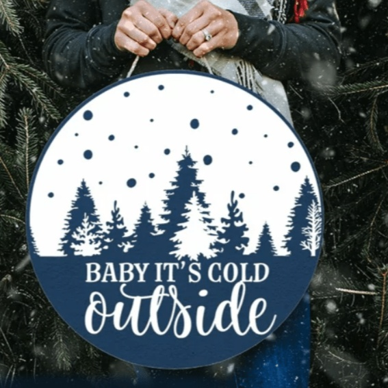 Handmade "Baby It's Cold Outside" wood sign with festive tree design.
